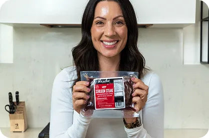 Customer holding a True Nature Sirloin Steak pack