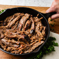 Cooked KC Shredded Brisket served in a cast-iron skillet