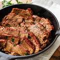 Cooked Texas Smoked Brisket served in a cast-iron skillet