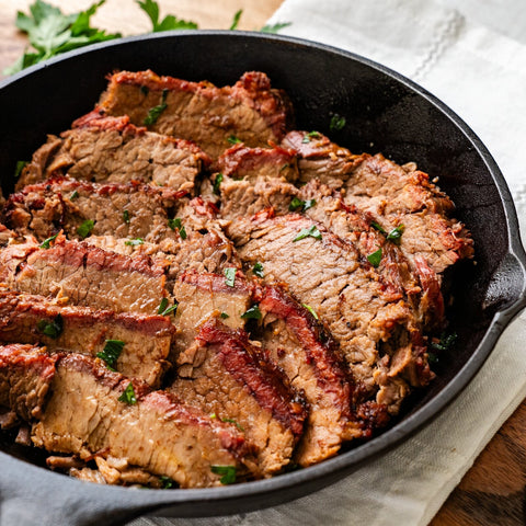Cooked Texas Smoked Brisket served in a cast-iron skillet