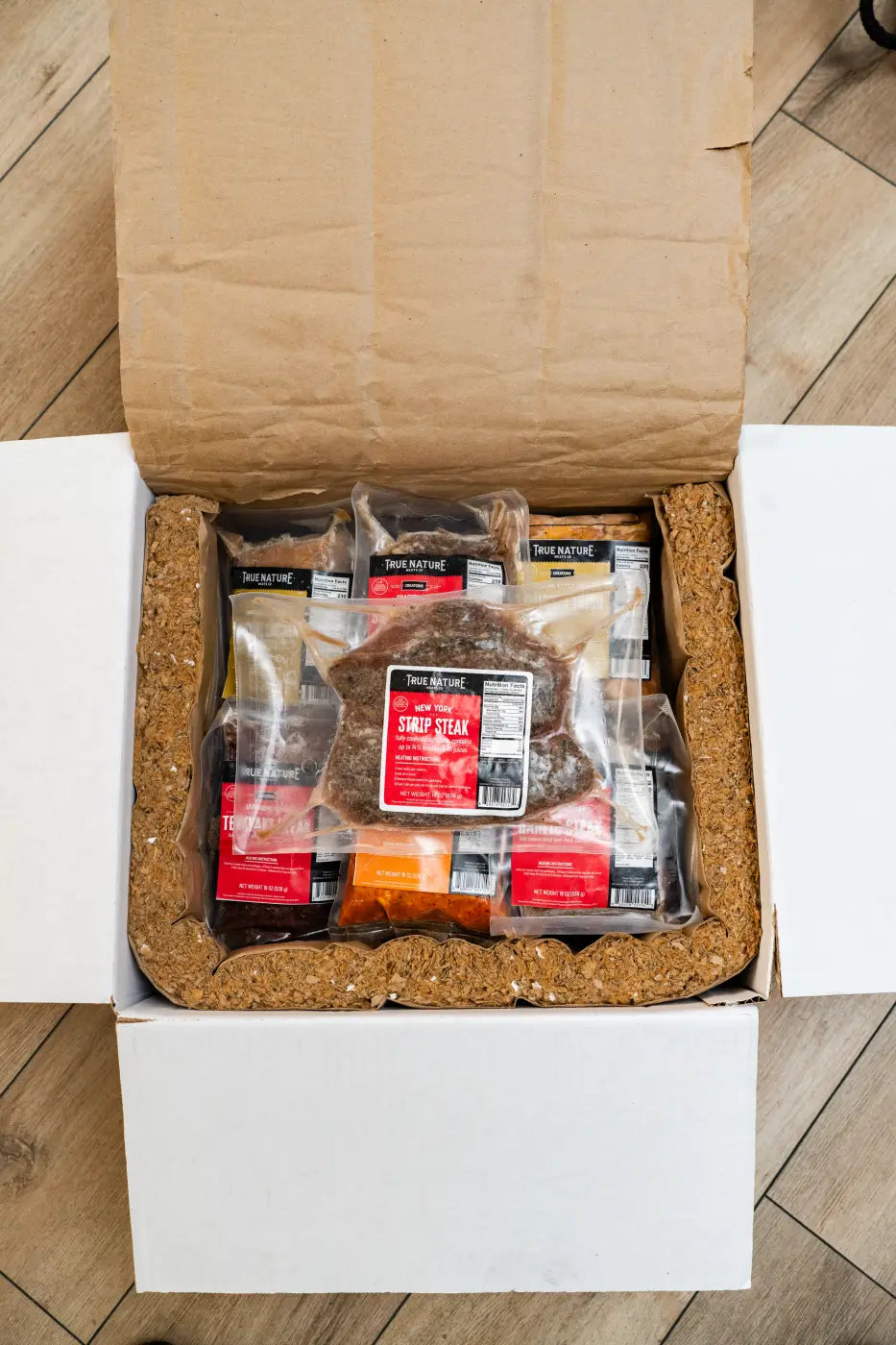 Opened delivery cooler with dry ice and vacuum sealed meat