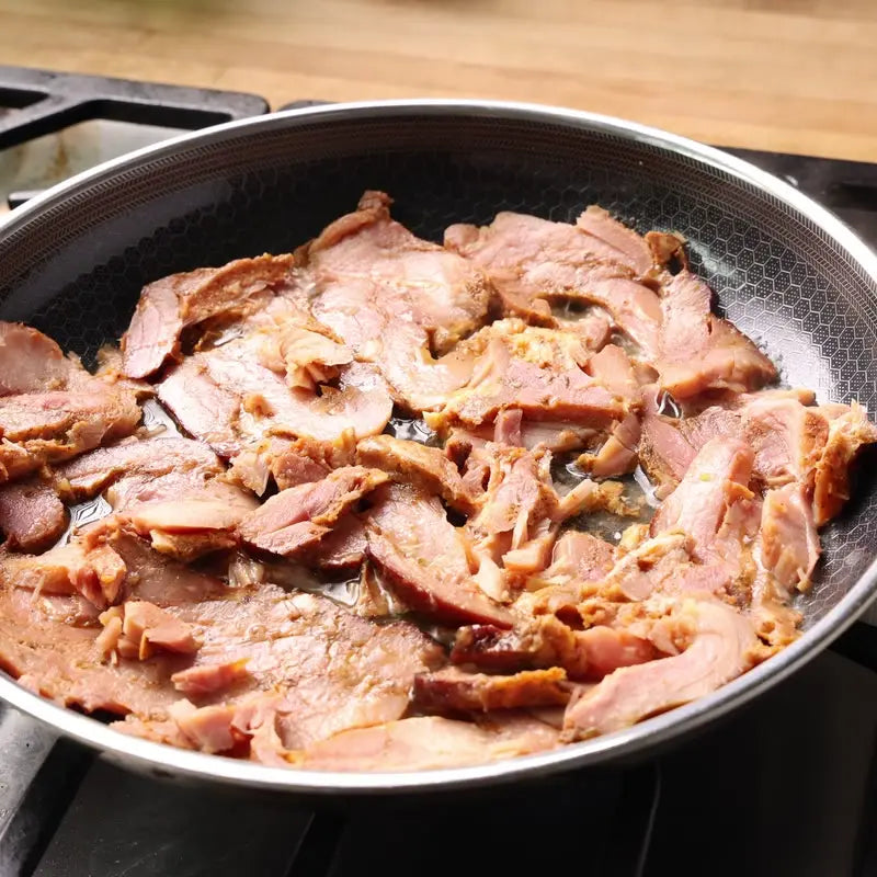 Cajun chicken sizzling in a pan