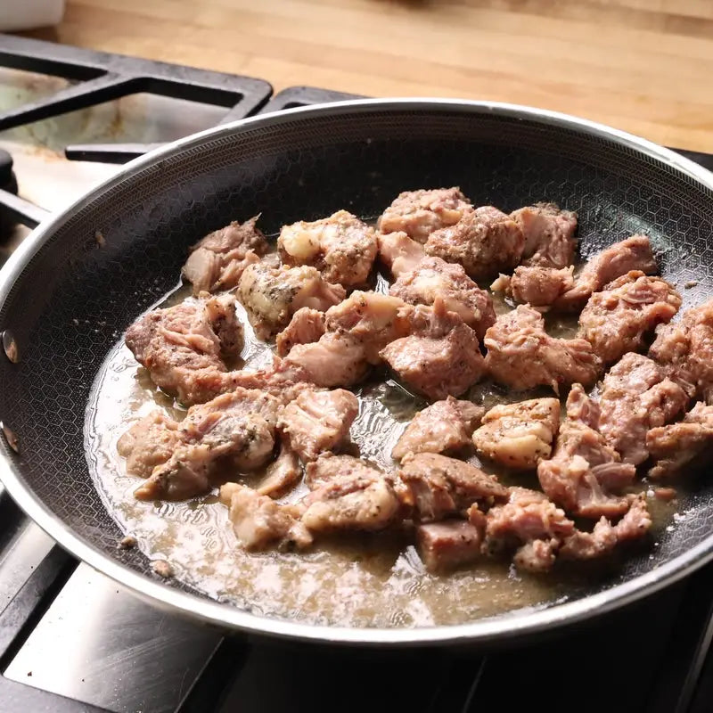 Hawaiian Kalua pork heating in a pan