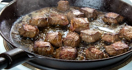 True Nature Meats searing in a skillet